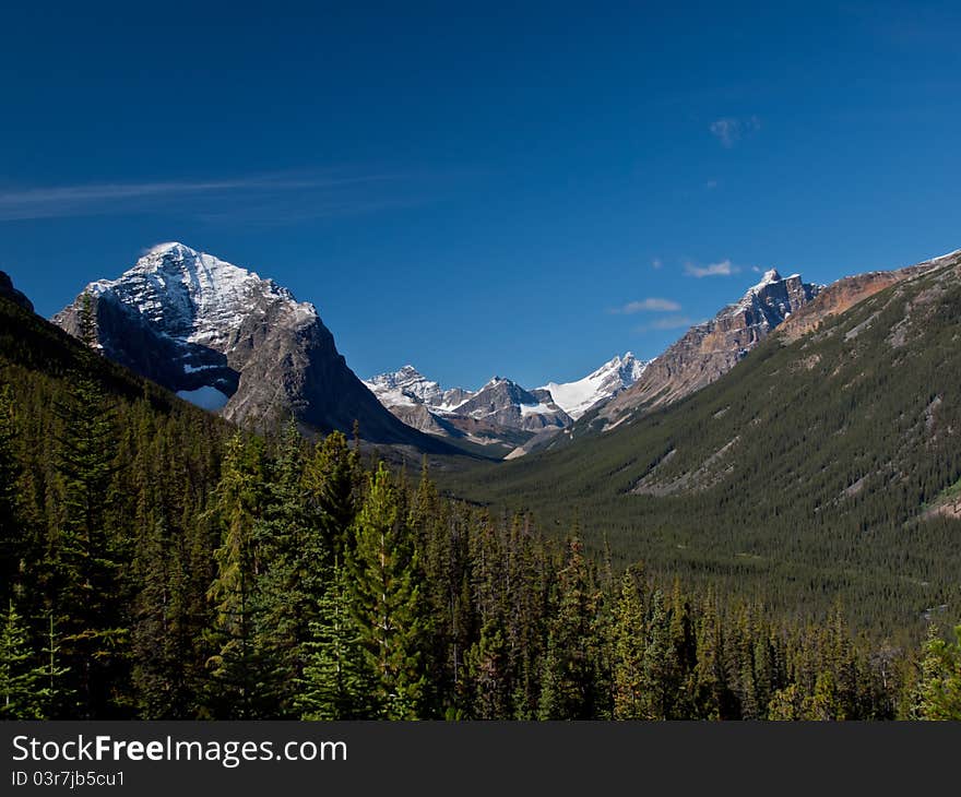 Mountains towering over a deep valley. Mountains towering over a deep valley.