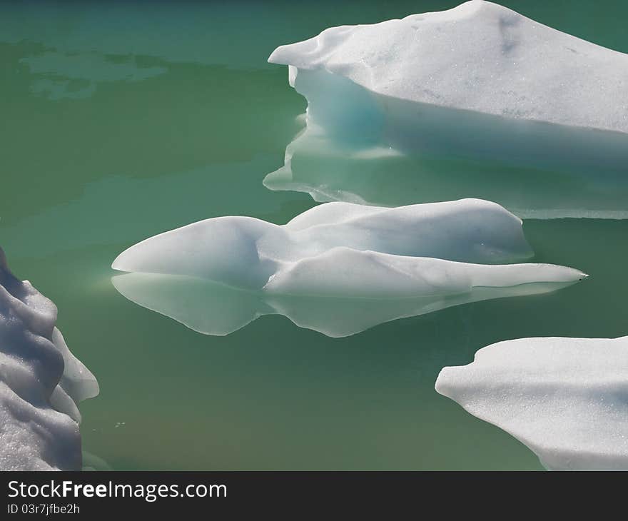 Pieces of ice floating in frigid glacial waters. Pieces of ice floating in frigid glacial waters.