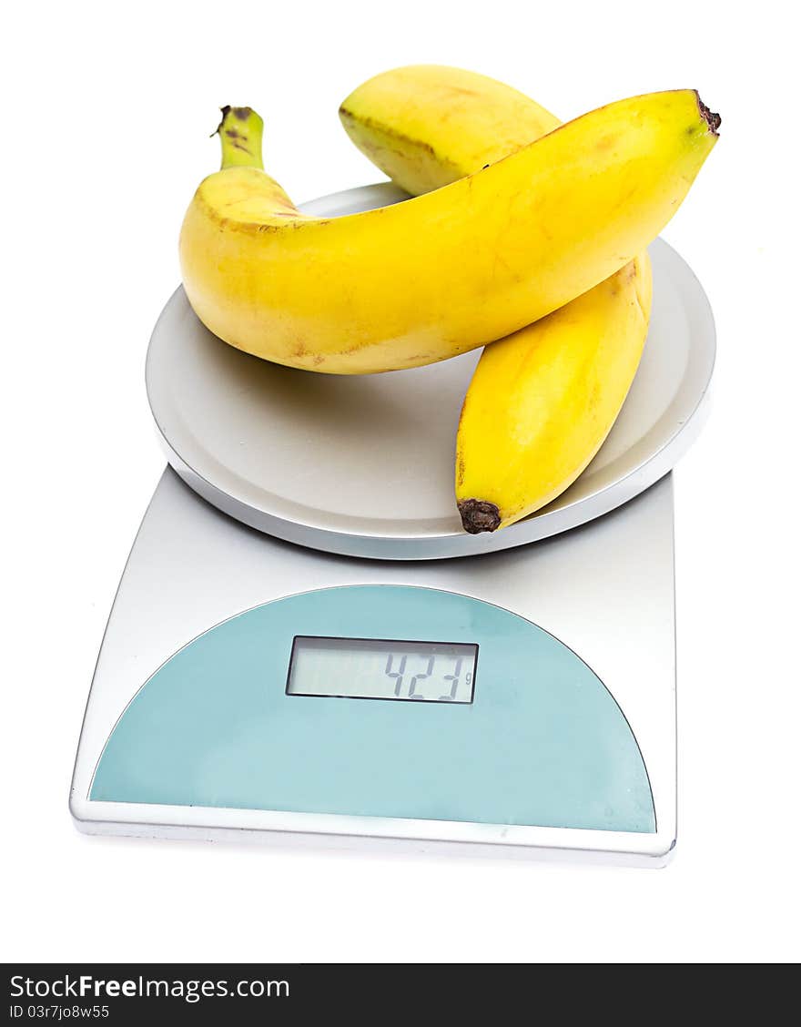 Bananas on the scales on a white background