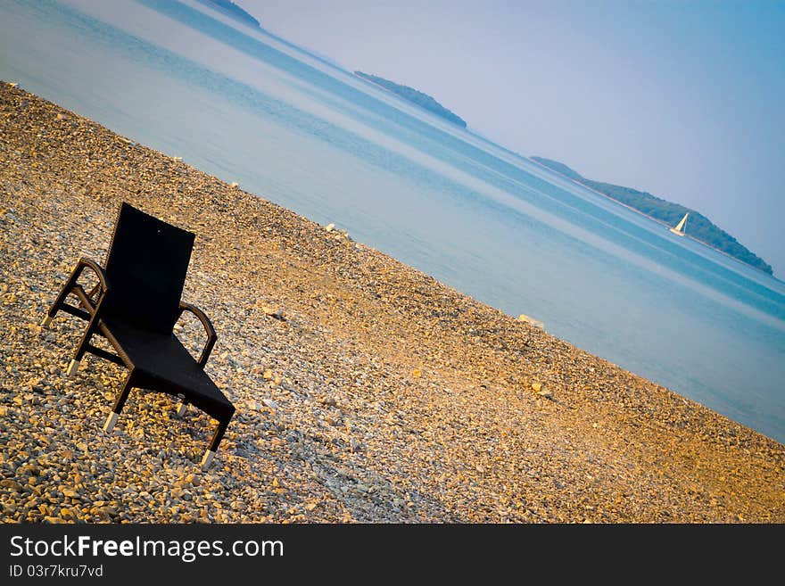 Beautiful croatian beach with one sunbed