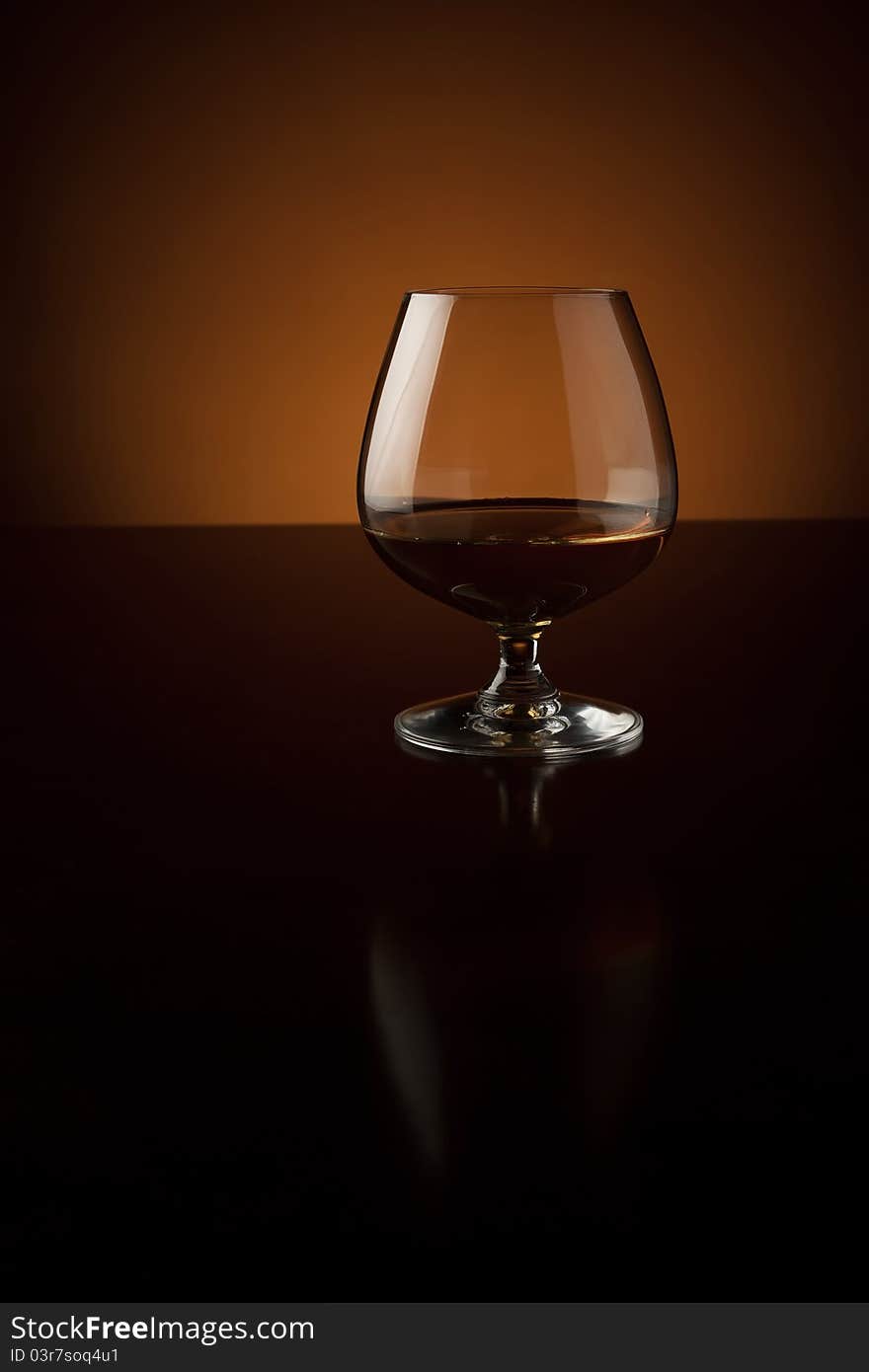 Glass of cognac at the bar counter with copy space. Glass of cognac at the bar counter with copy space