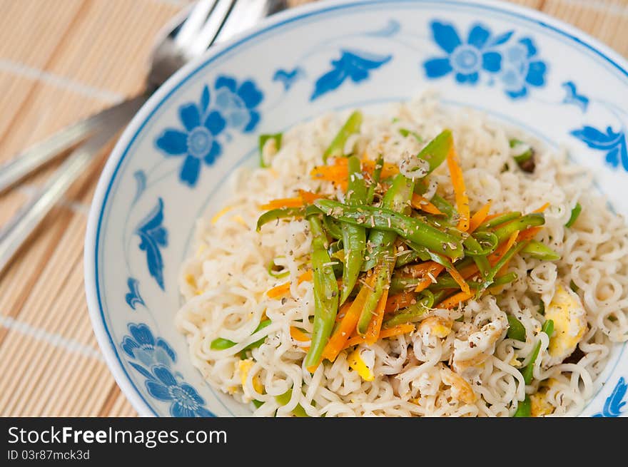 Oriental style mixed vegetable noodles topped with fragrant spices. Oriental style mixed vegetable noodles topped with fragrant spices.