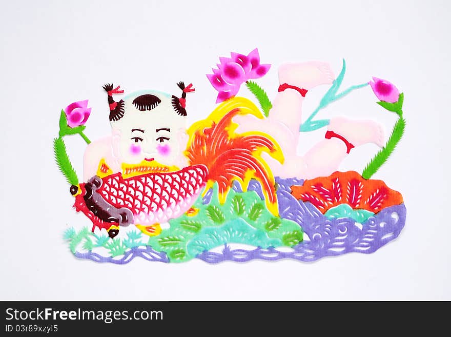 Paper-cutting is a traditional Chinese folk art. Paper-cut of a boy carrying fish represents good luck and happiness.