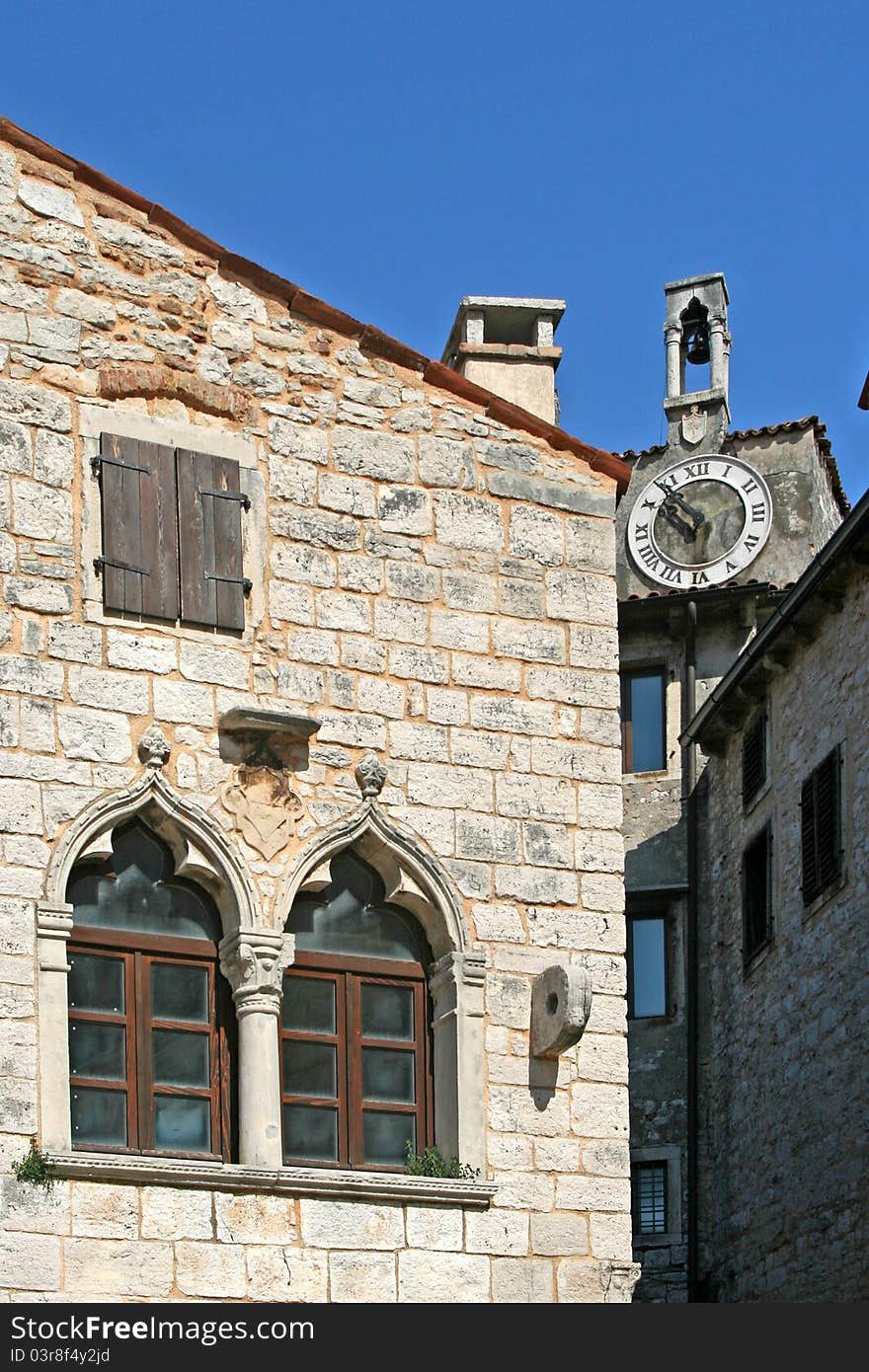 Venetian windows on the old palace with the clock