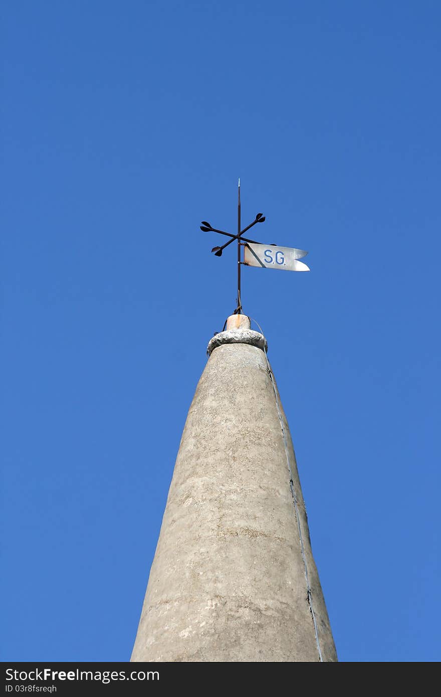 Stone church tower and the weather vane