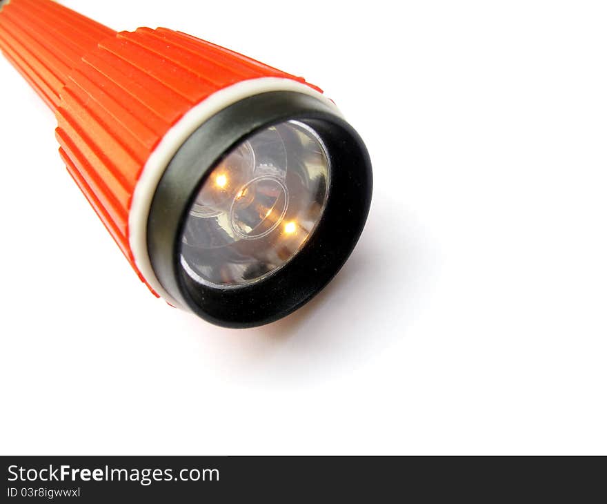 A red torch with lights on isolated on white background.