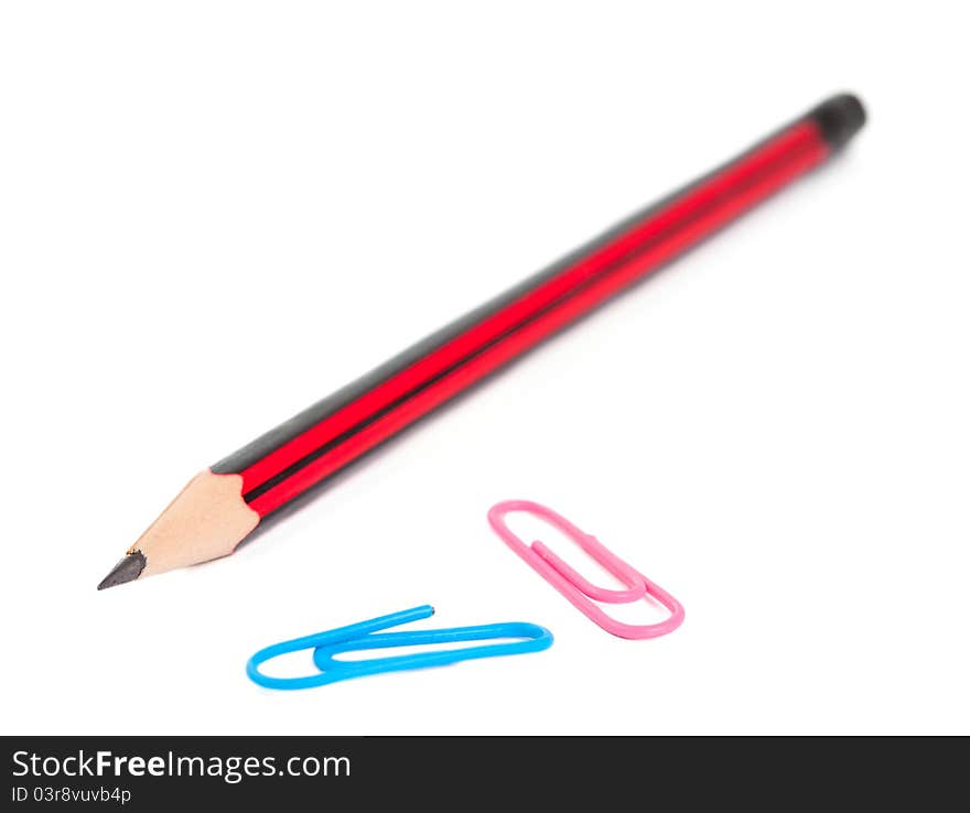 Paper clips and a pencil on a white background