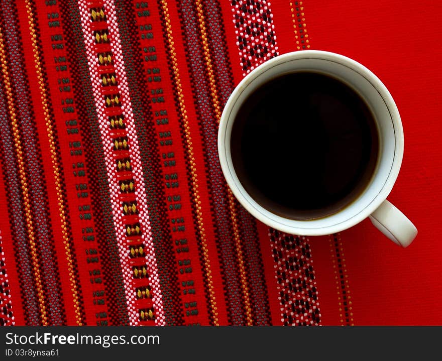 A cup of coffee on the red background. A cup of coffee on the red background.