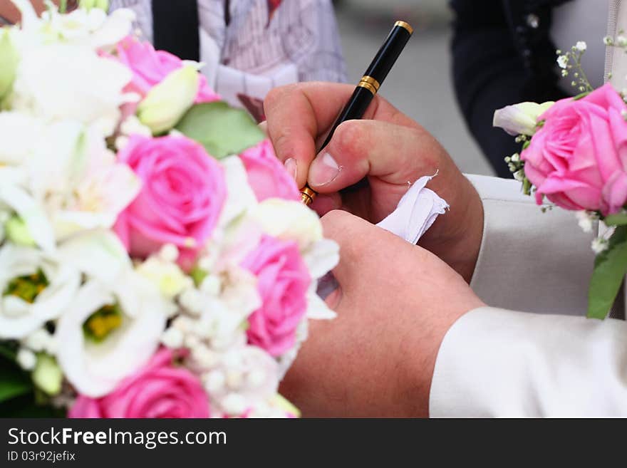 The image of two hands with a pen