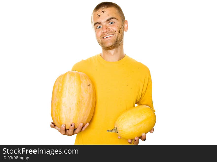 Handsome young man holds a lot of different pumpkin in his hands. Lots of copyspace and room for text on this isolate. Handsome young man holds a lot of different pumpkin in his hands. Lots of copyspace and room for text on this isolate