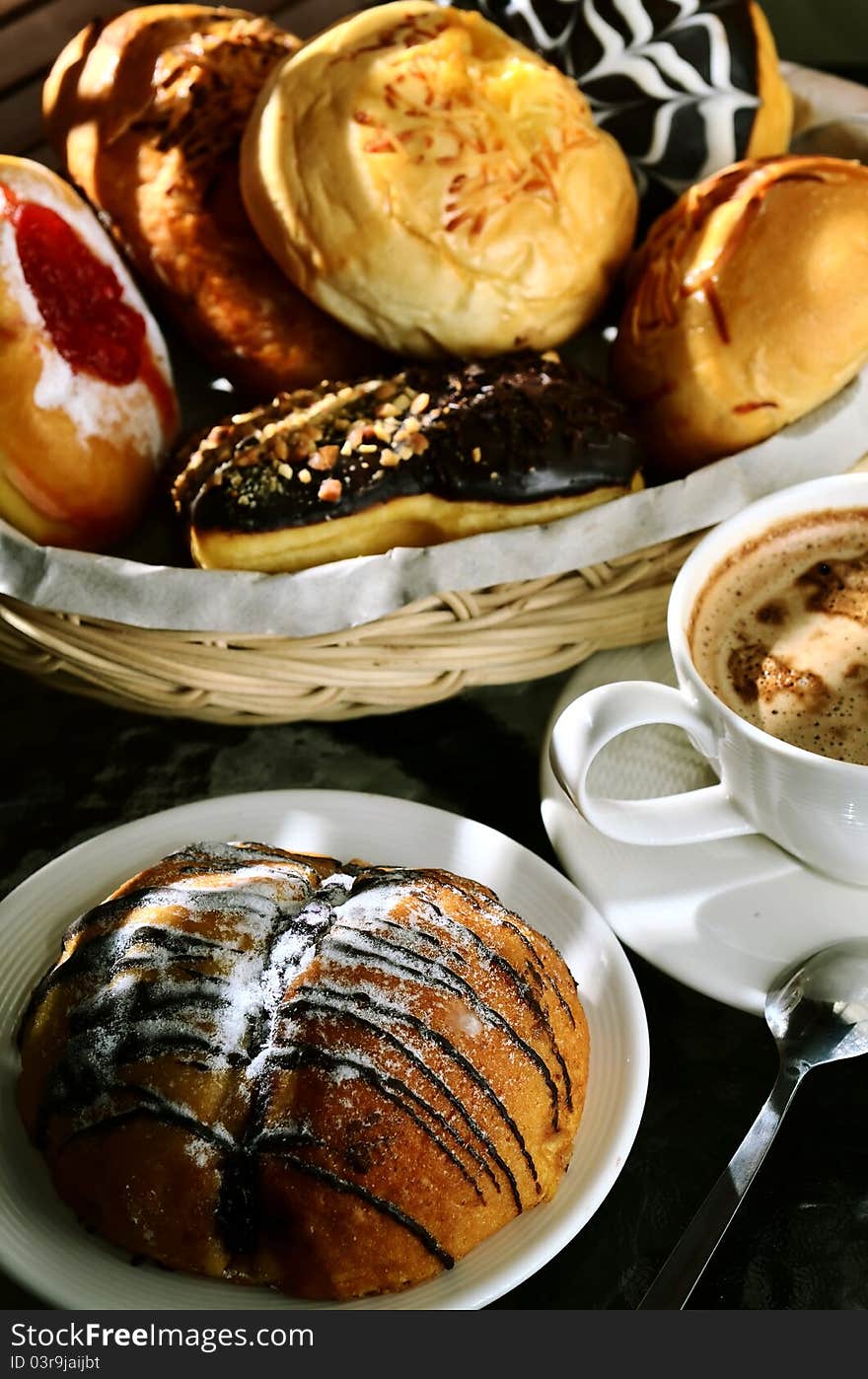 Delicious bread sweetened with multi flavour taste served in the background and Chocolate bread as the main focus. Great images for food and beverages article or any design involving food and drinks. Delicious bread sweetened with multi flavour taste served in the background and Chocolate bread as the main focus. Great images for food and beverages article or any design involving food and drinks.