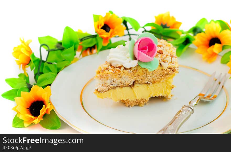 Piece of birthday cake with flowers and roses