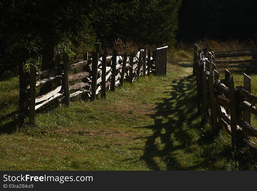 The morning sun bathed wooden fence was built in the traditional way