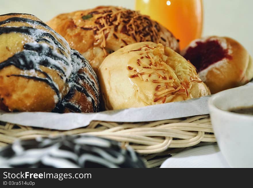 Bread in a basket with morning light. Great images for food and beverages article or any design involving food and drinks. Bread in a basket with morning light. Great images for food and beverages article or any design involving food and drinks.