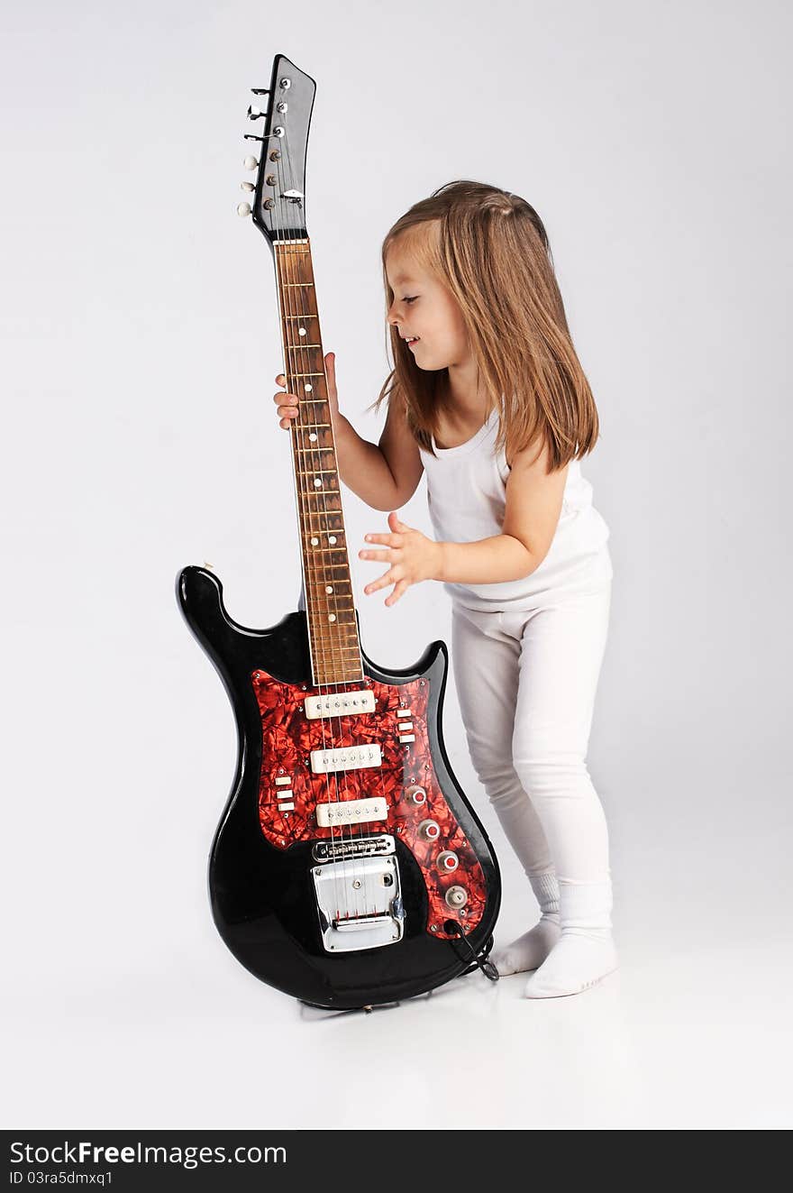 Small Child Hold Red Acoustic Guitar. Music