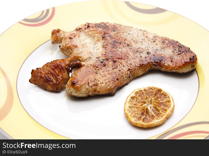 Turkeys steak roasted with lemon on plate