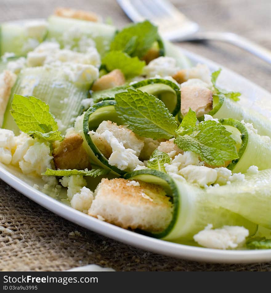 Fresh salad with cucumber and cheese. Selective focus