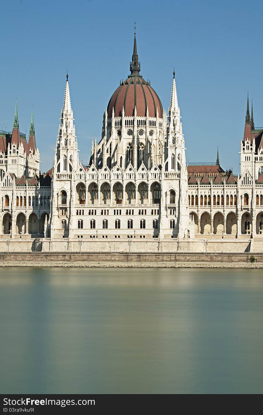 Central portion of the Hungarian parliament building on the blue river danube in Budapest Hungary. Central portion of the Hungarian parliament building on the blue river danube in Budapest Hungary