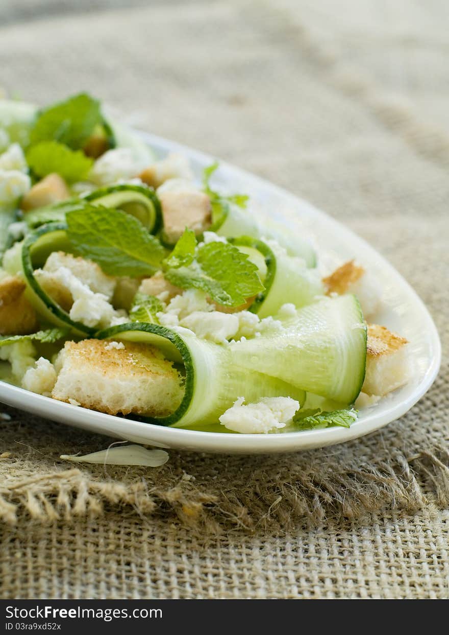 Fresh salad with cucumber and cheese. Selective focus