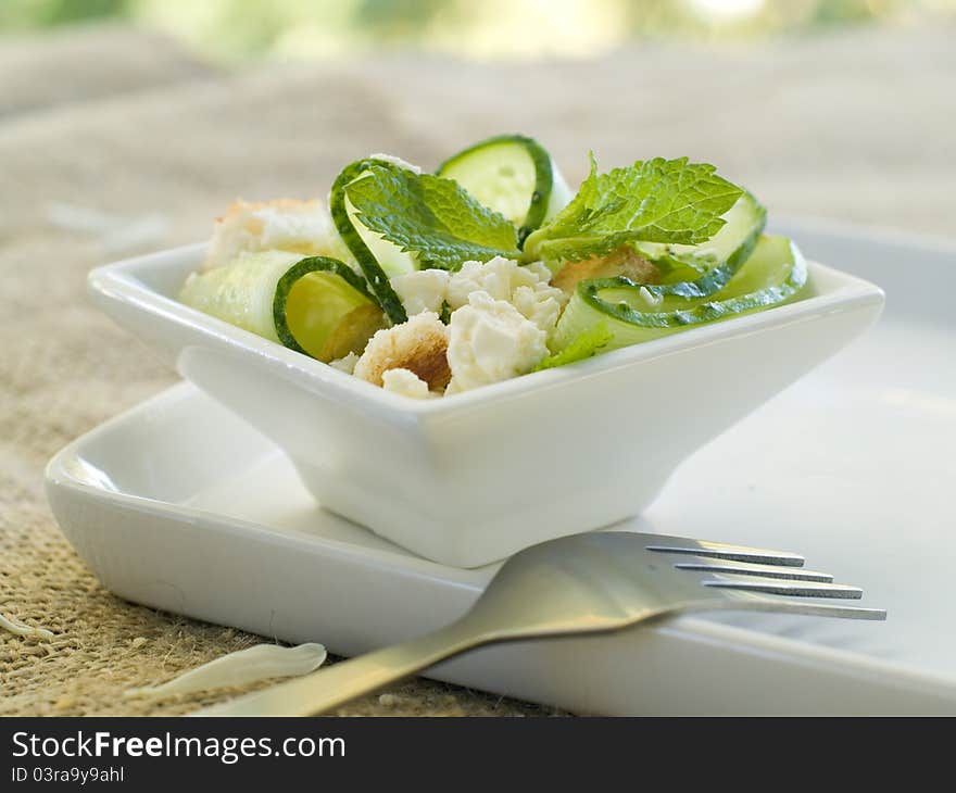 Fresh salad with cucumber and cheese. Selective focus