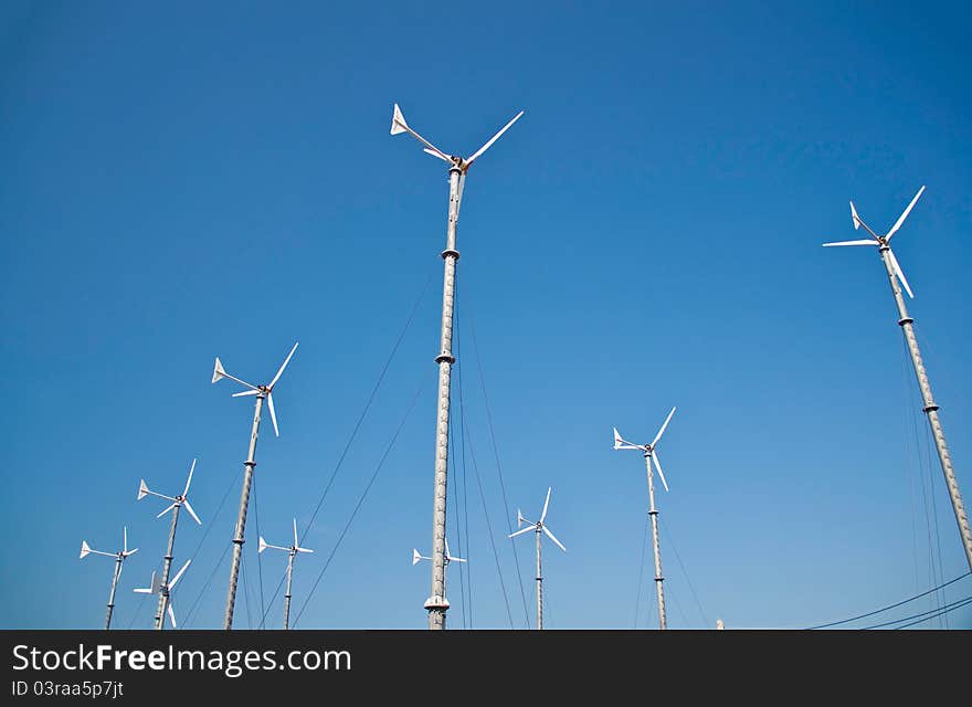 Wind turbine on blue sky background. Wind turbine on blue sky background