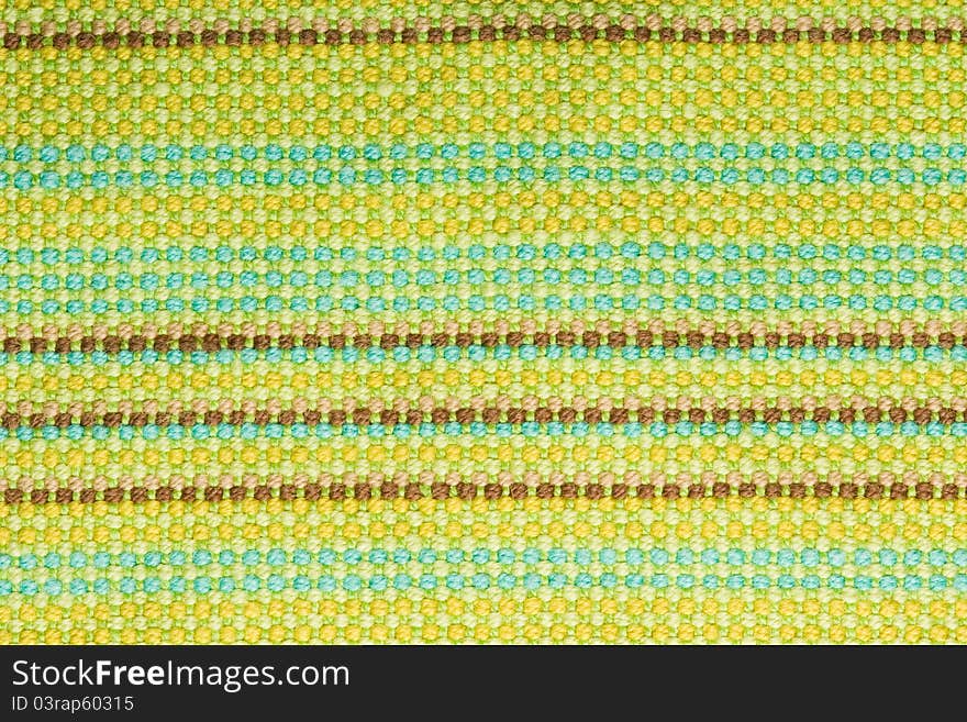 Textile background with colorful green, beige and yellow stripes