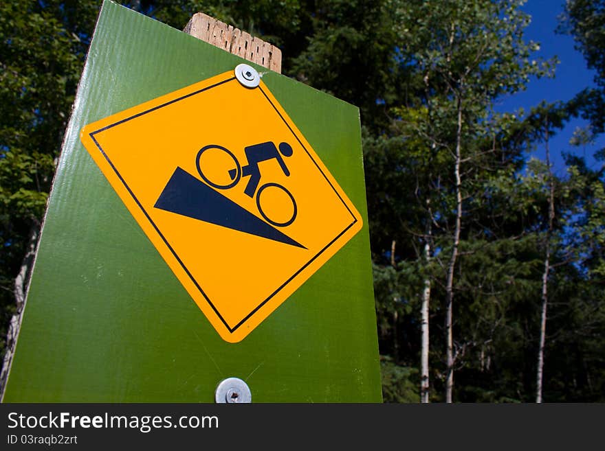 A cycle path sign warning of a steep hill. A cycle path sign warning of a steep hill