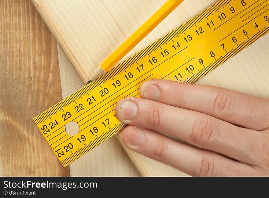 Hand and tools on a wooden background. Hand and tools on a wooden background.