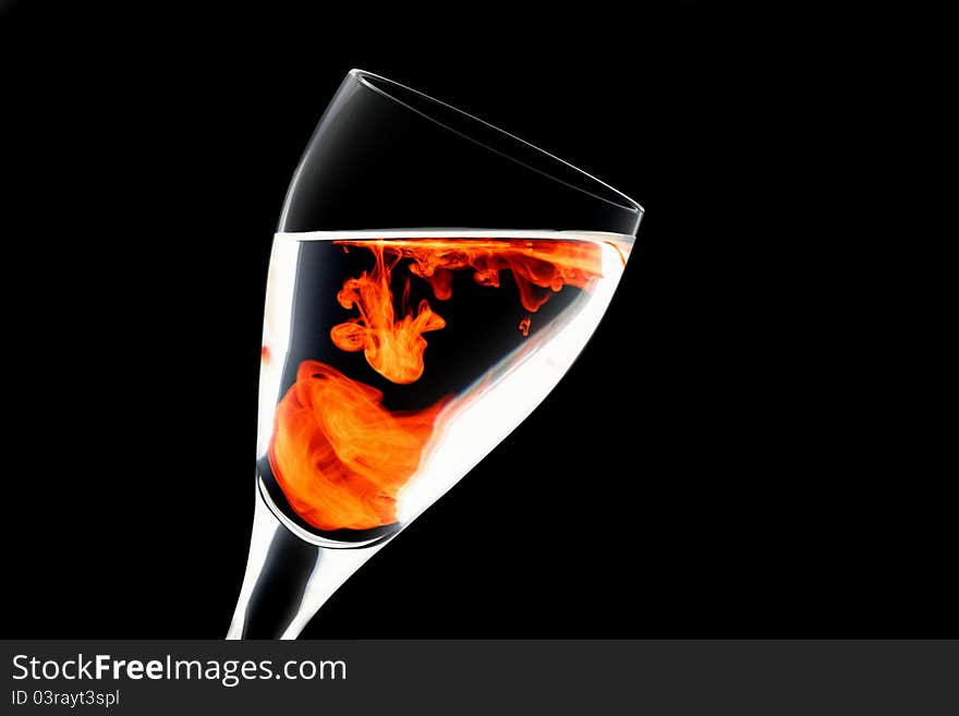 Negative image of wine glass with a splash of food colouring set against a white background. Negative image of wine glass with a splash of food colouring set against a white background