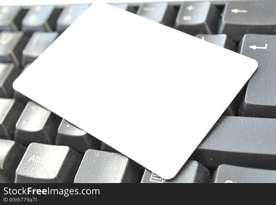 Blank contact card on a computer keyboard. Blank contact card on a computer keyboard