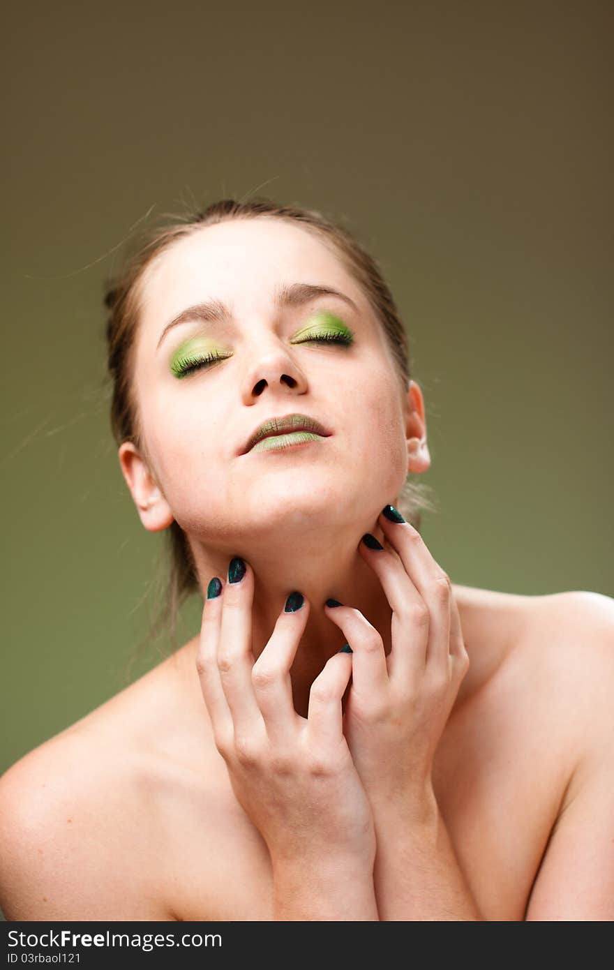 Ecology concept 
beautiful woman with luxury makeup green manicure, lips and cockade