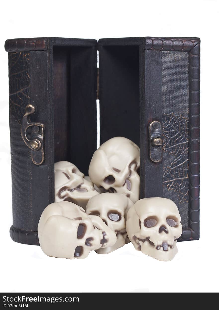 Plastic human skulls in a wooden chest