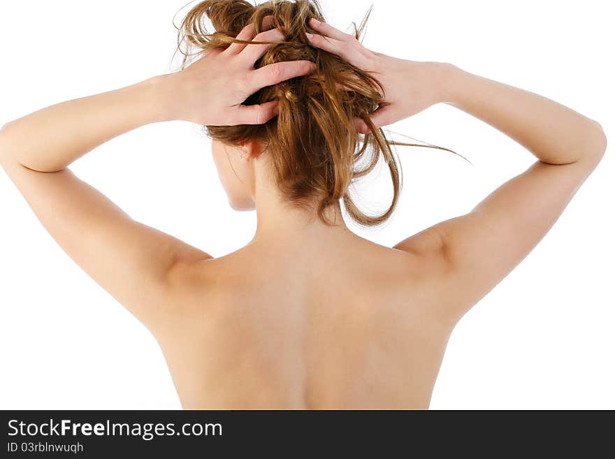 Young woman poses holding her hair. Young woman poses holding her hair.