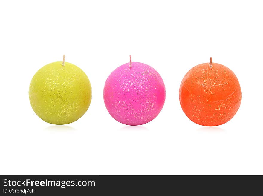 Image of three round coloured candles decorated with shiny speckles, isolated on a white background. Clipping path included. Image of three round coloured candles decorated with shiny speckles, isolated on a white background. Clipping path included.