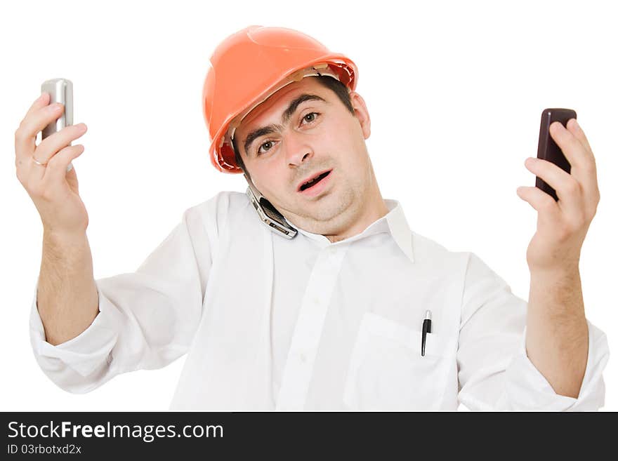 Busy businessman wearing a helmet with a mobile phones on a white background. Busy businessman wearing a helmet with a mobile phones on a white background.