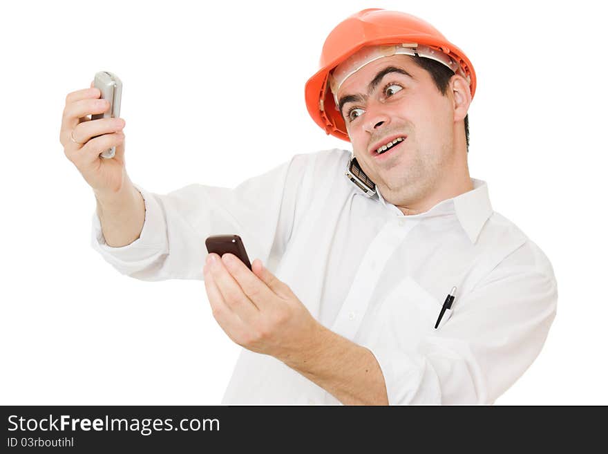 Busy businessman wearing a helmet with a mobile phones on a white background. Busy businessman wearing a helmet with a mobile phones on a white background.