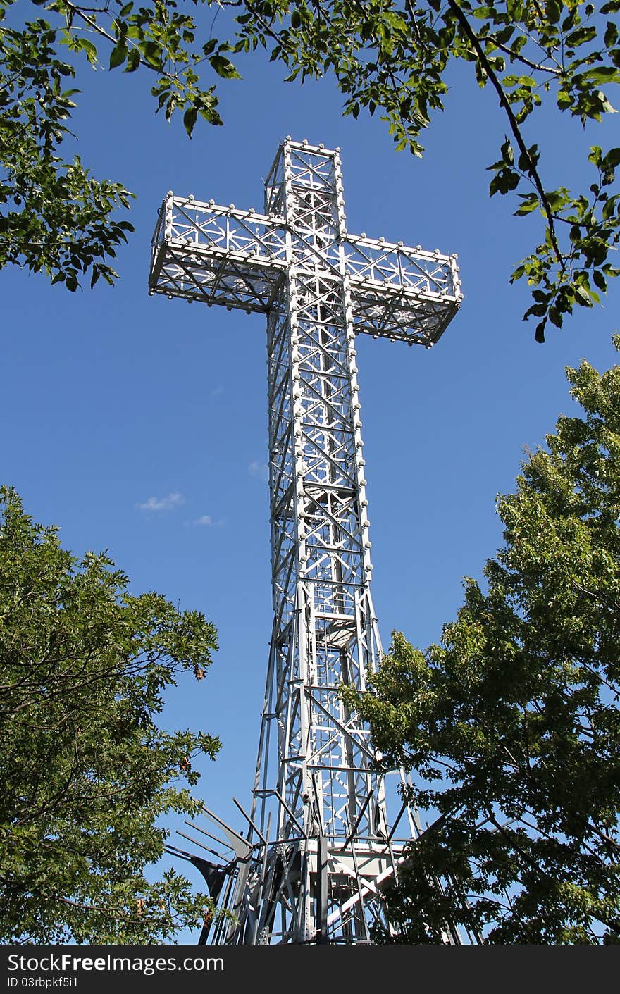 Giant Metal White Cross Against Blue Sky