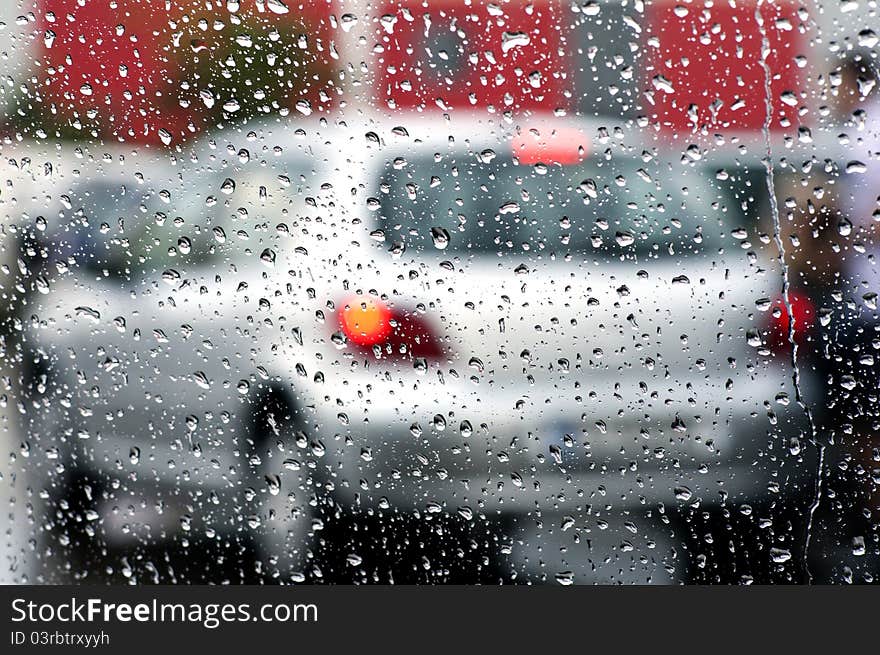 Photo of cars in the rain across the windshield. Photo of cars in the rain across the windshield.