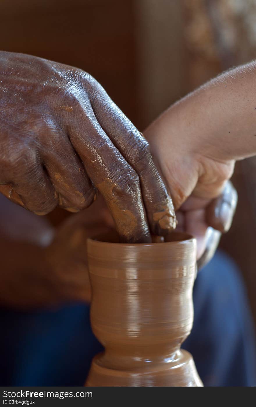 An old hand teaching the young hand, concept of passing it on to the next generation. An old hand teaching the young hand, concept of passing it on to the next generation