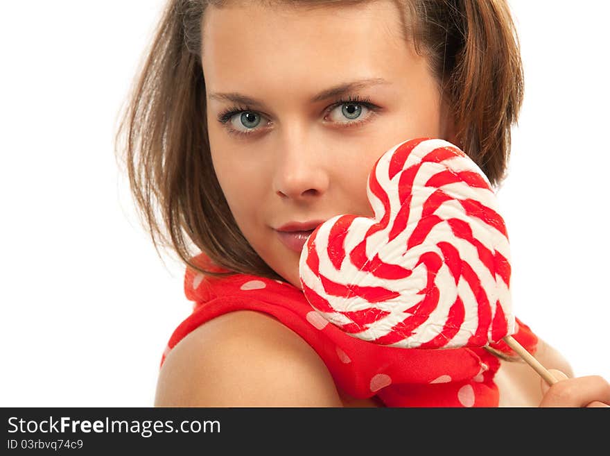 Close-up portrait of young woman with heart shaped lollipop. Close-up portrait of young woman with heart shaped lollipop