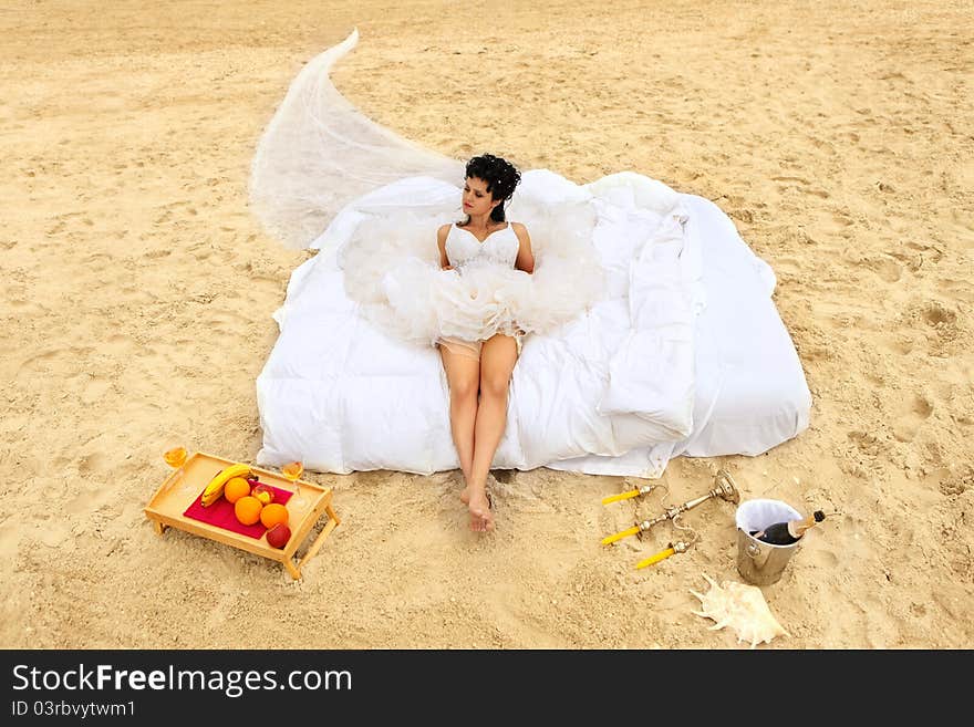 Bride in bed at the coastline.