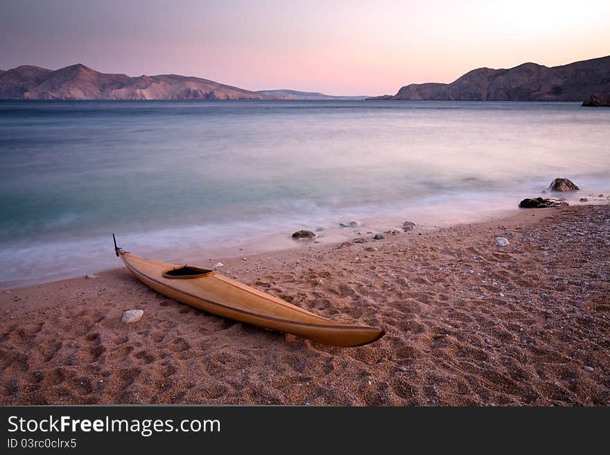 Wooden kayak on pebble beach. (Baska - Krk - Croatia)