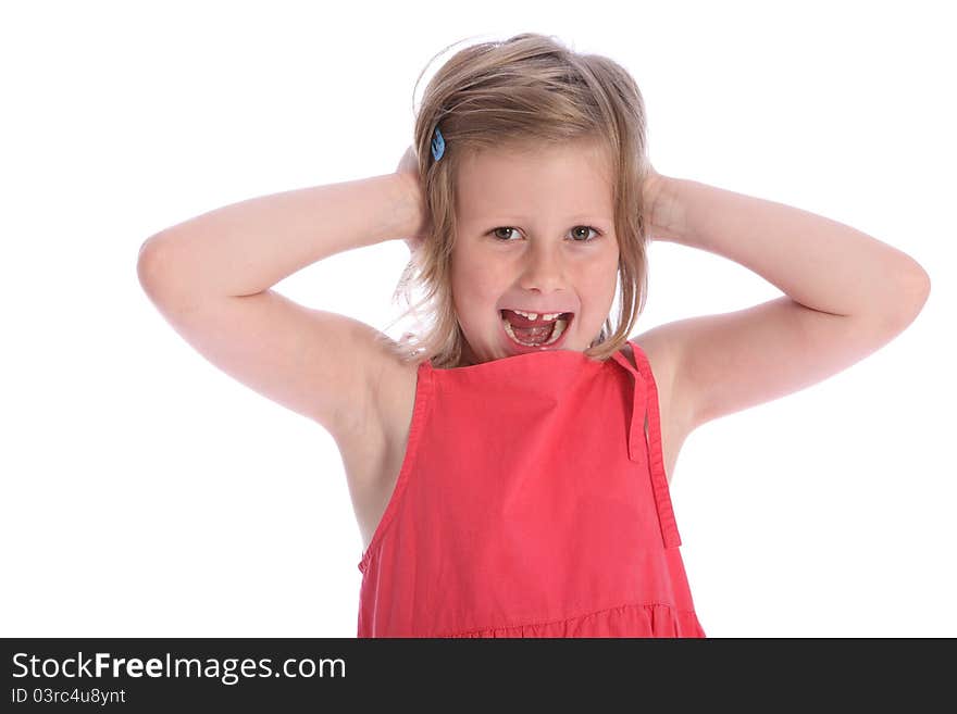 Happy six year old primary school girl wearing coral pink dress having fun holding hands over her ears and laughing. Happy six year old primary school girl wearing coral pink dress having fun holding hands over her ears and laughing.