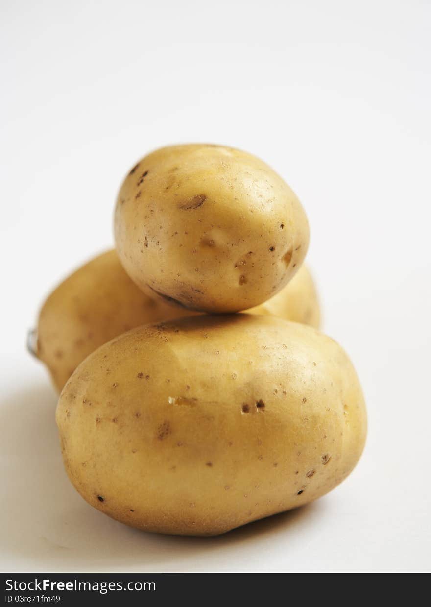 Bunch of potatoes on white background close up shoot