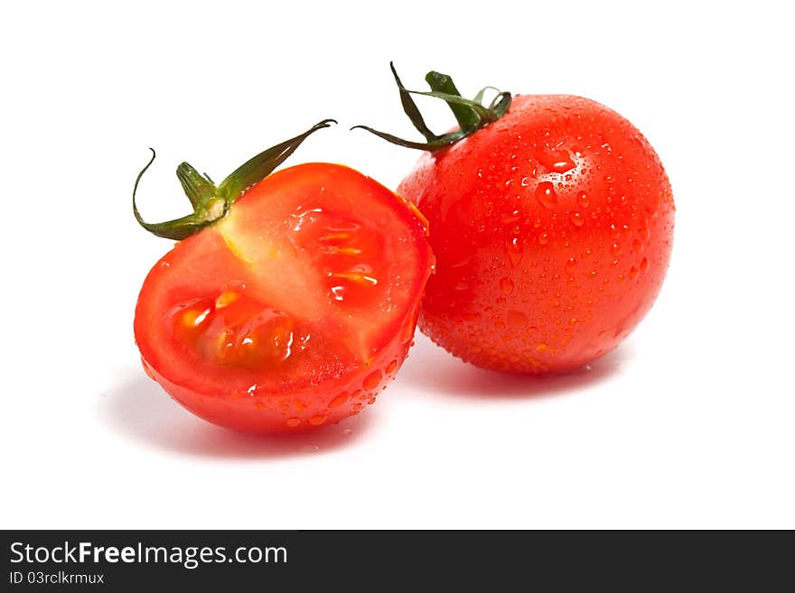 Red tomato with leaf and a half