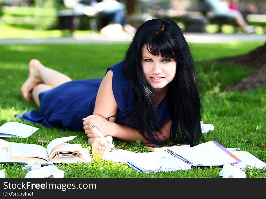 Beautiful girl studying in park