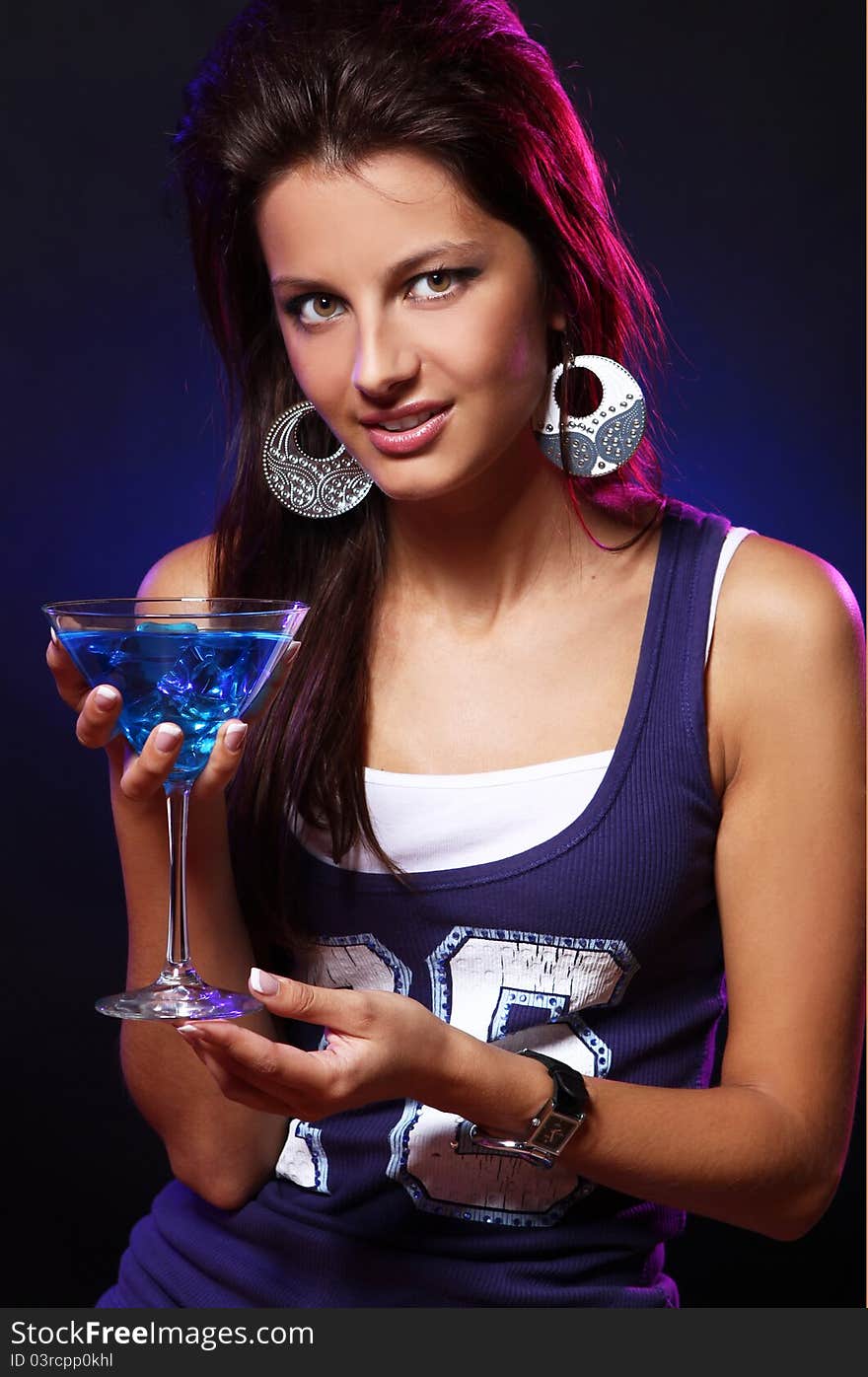 Young and beautiful woman with a blue cocktail in the nightclub. Young and beautiful woman with a blue cocktail in the nightclub