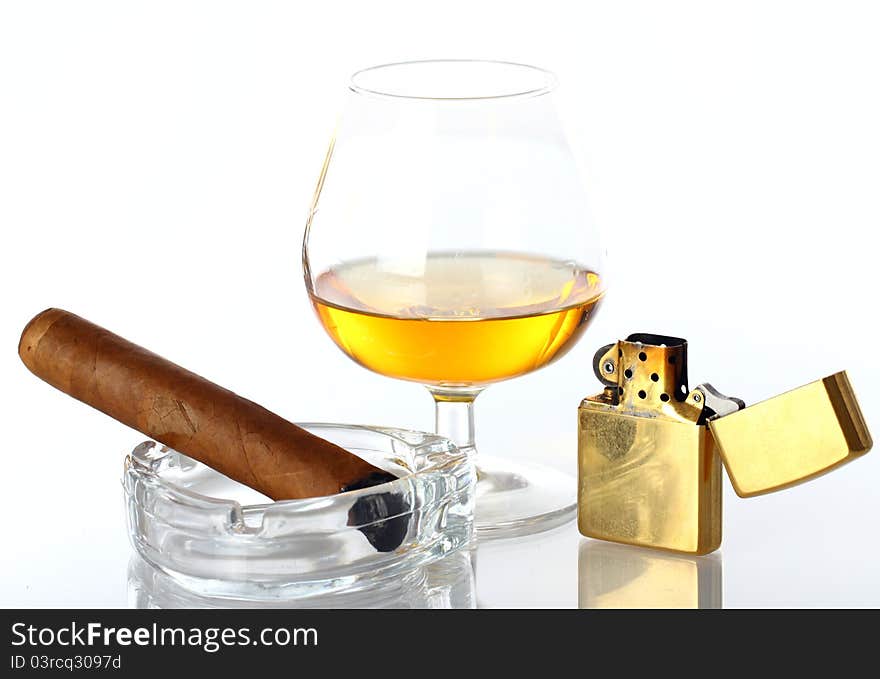 Glass of Whiskey and Cigar against white background