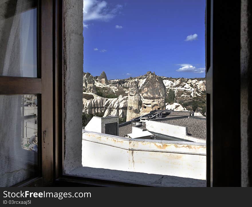 Goreme Valley and Uchisar on the hill, limestone fairy chimneys and terrain from a bedroom window, landscape with crop space and copy area. Goreme Valley and Uchisar on the hill, limestone fairy chimneys and terrain from a bedroom window, landscape with crop space and copy area