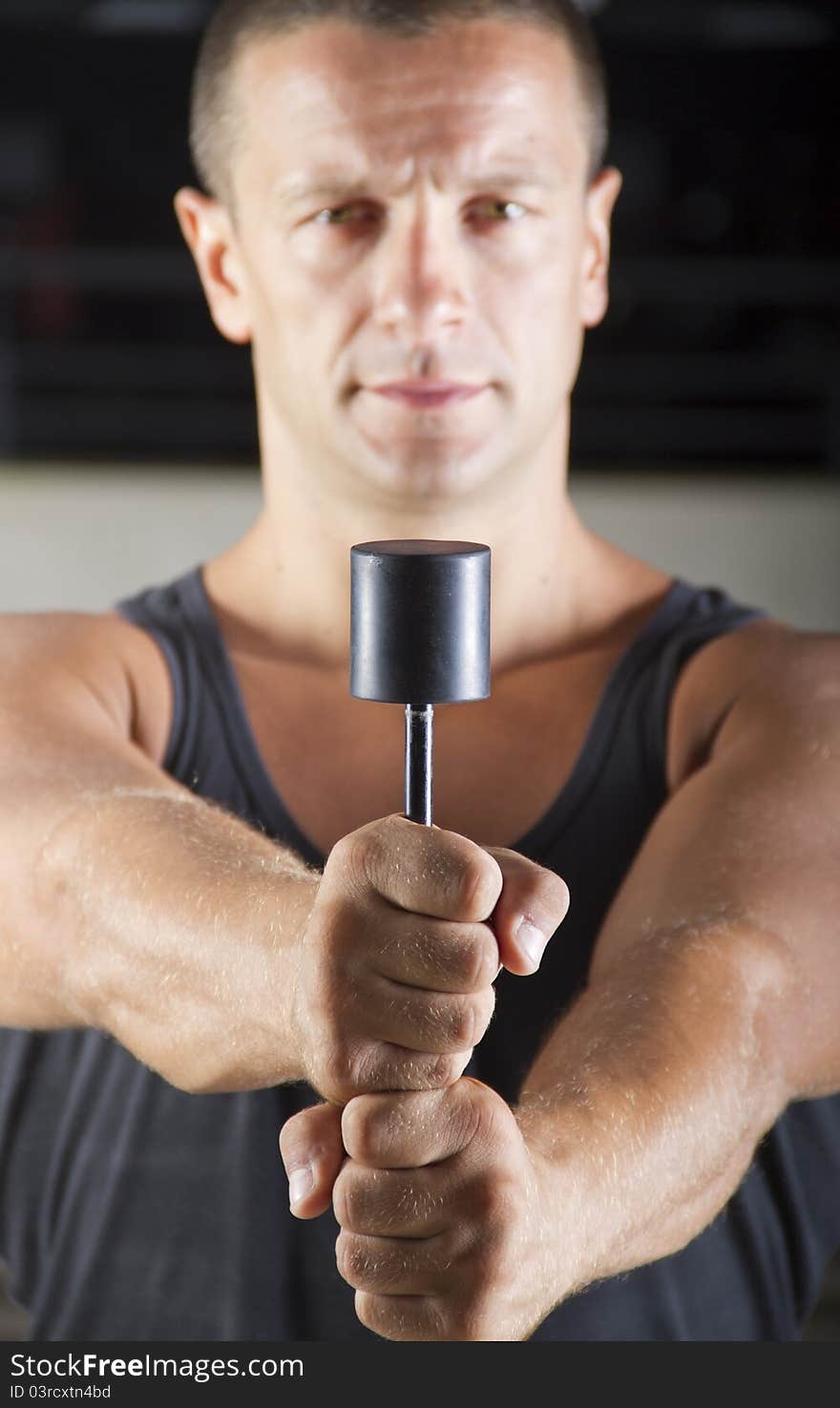 Fitness instructor posing in the gym while doing exercises with some kind of springs. Fitness instructor posing in the gym while doing exercises with some kind of springs